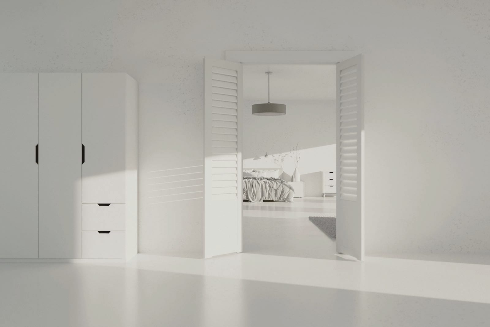 An empty room in daylight with plain fitted cabinets along one wall