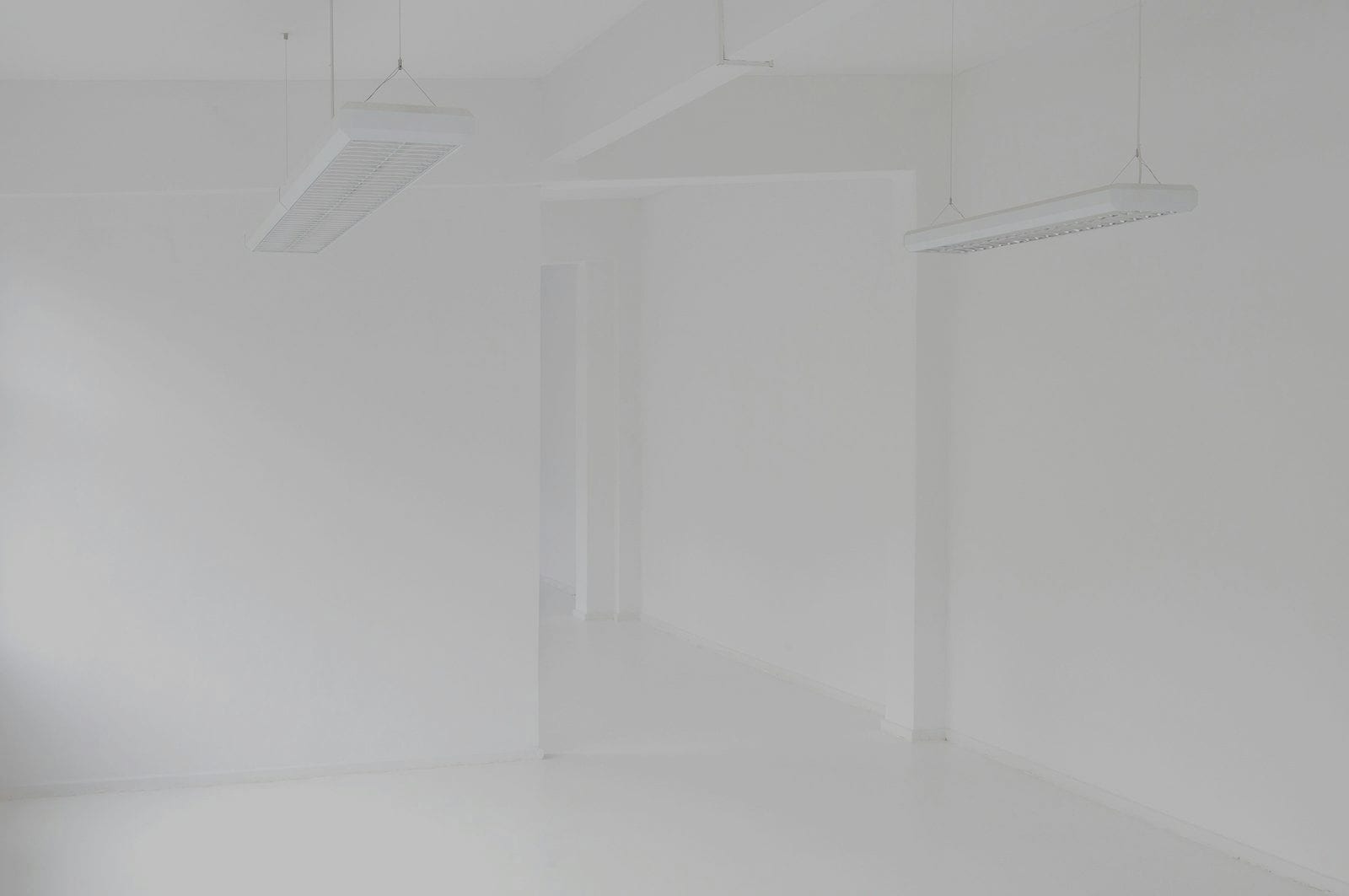 A corner of a white room in flat daylight